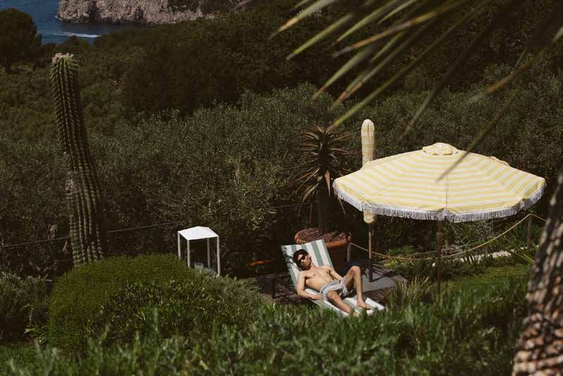 Sunbathing under a striped umbrella