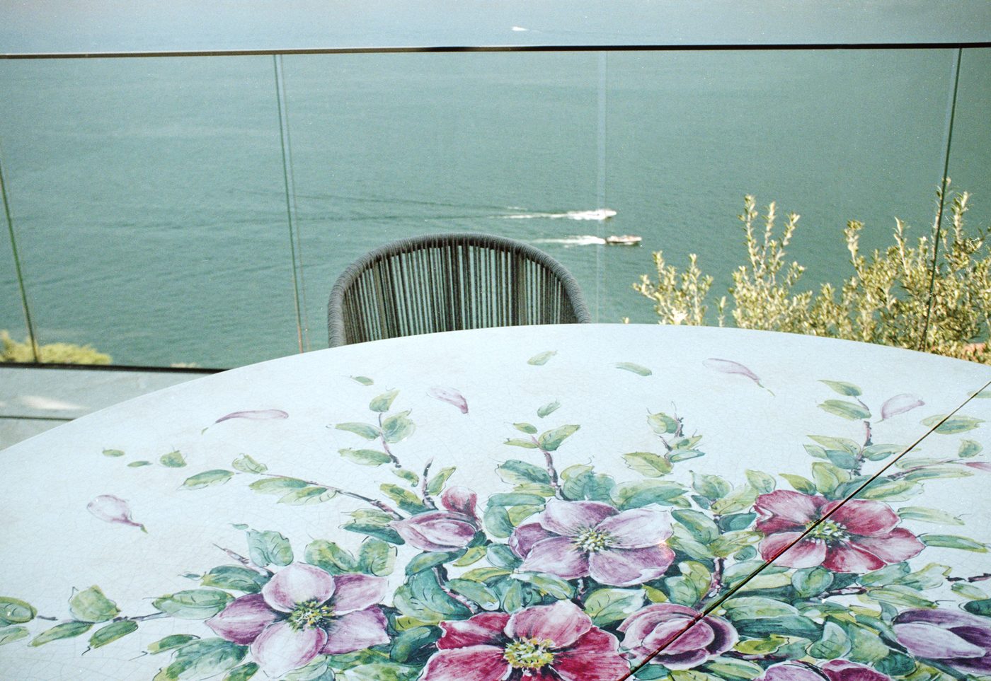 Floral tablecloth on a terrace above the lake
