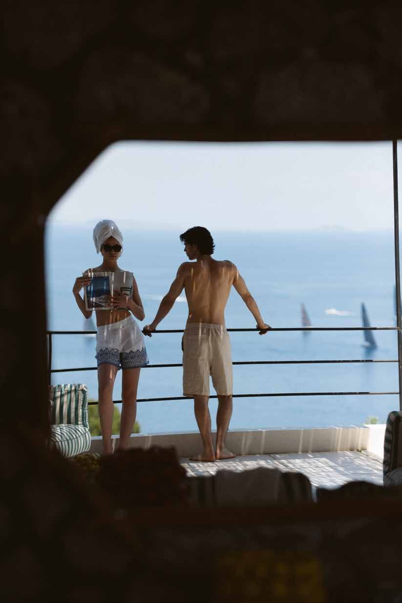 Couple on a terrace framed by a window