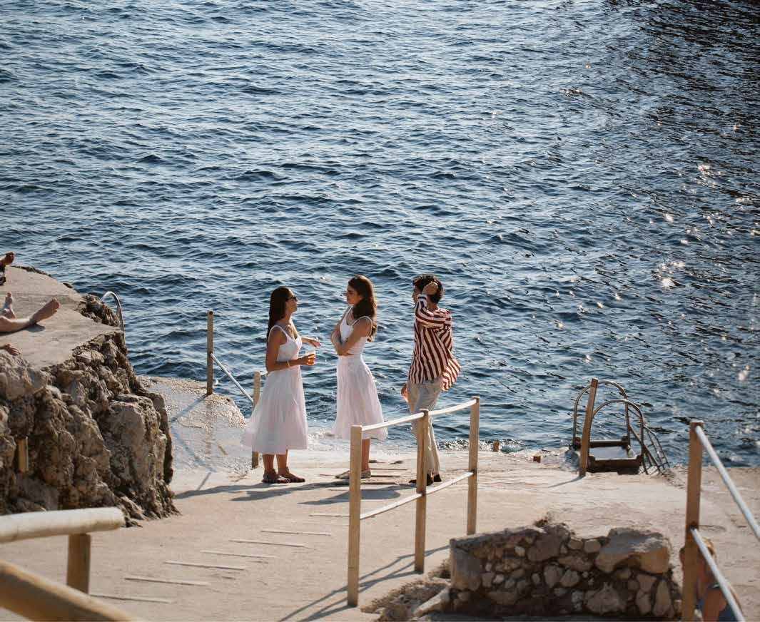 Three women on the rocks by the sea